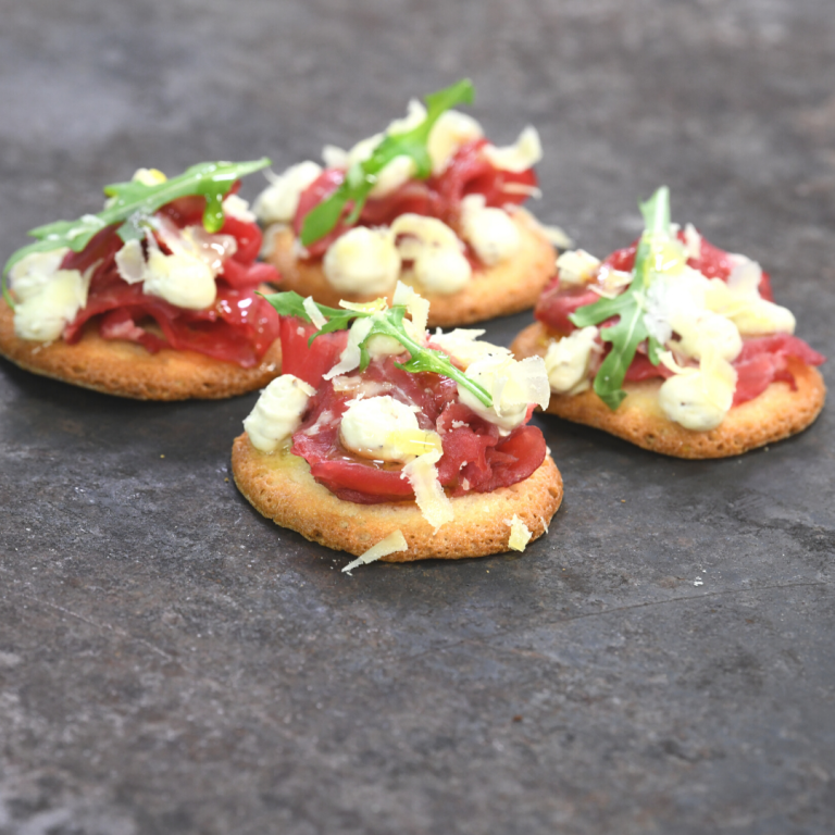 Teula biscuits combined with beef carpaccio, mustard foam, comté  cheese and arugula